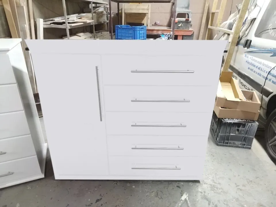 White chest of drawers with five drawers and a tall single cupboard door on the left, with long silver bar handles (colour preview)