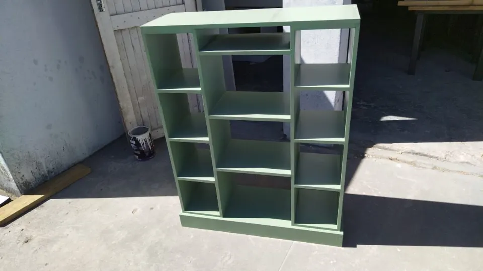 Green open cube bookcase with different sized shelves