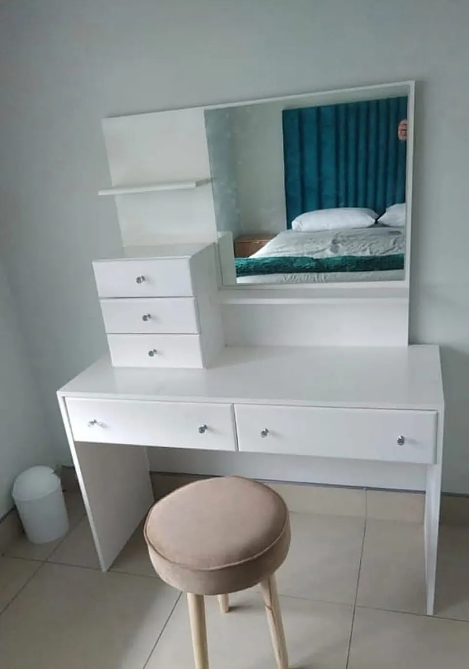White dressing table with mirror, three small drawers, two wide drawers and a stool