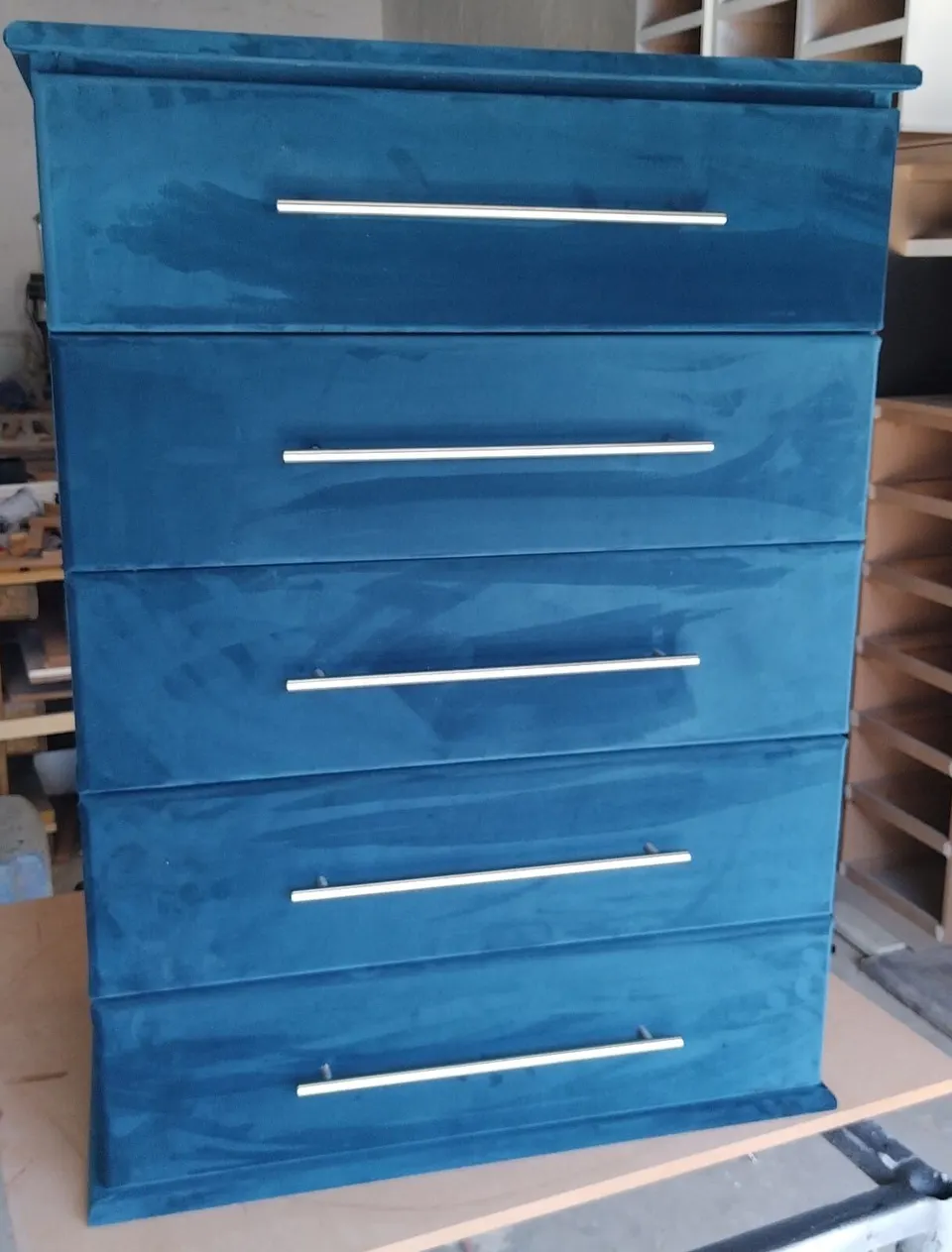 Blue velvet-wrapped five-drawer chest of drawers with long bar handles